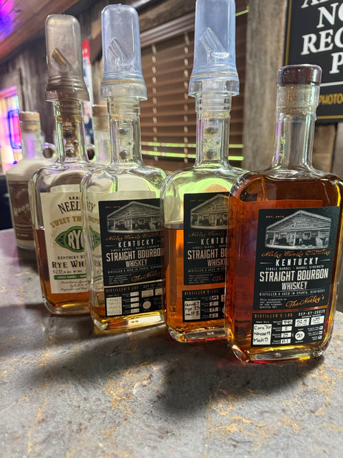 Four bottles of Neeley Family Distillery whiskey