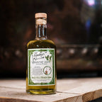 Bottle of Neeley's Absinthe Verte on a wooden surface with a blurred background