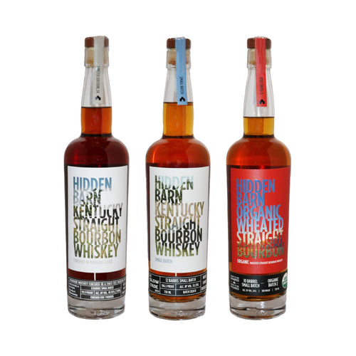Three bottles of Hidden Barn Kentucky Straight Bourbon Whiskey on a white background