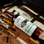 Bottle of Neeley Family Distillery Sweet Thumped Rye Whiskey Over A Wooden Barrel